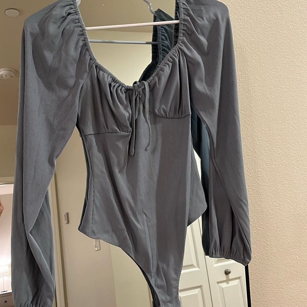 Blue body suit, never worn. Size Medium.